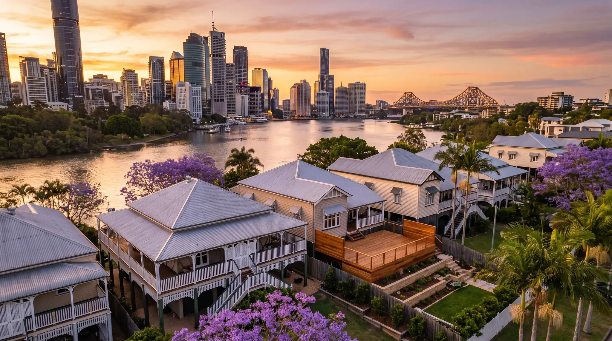 Queenslander homes among jacarandas with a new deck, the Brisbane River, CBD and Story Bridge beyond